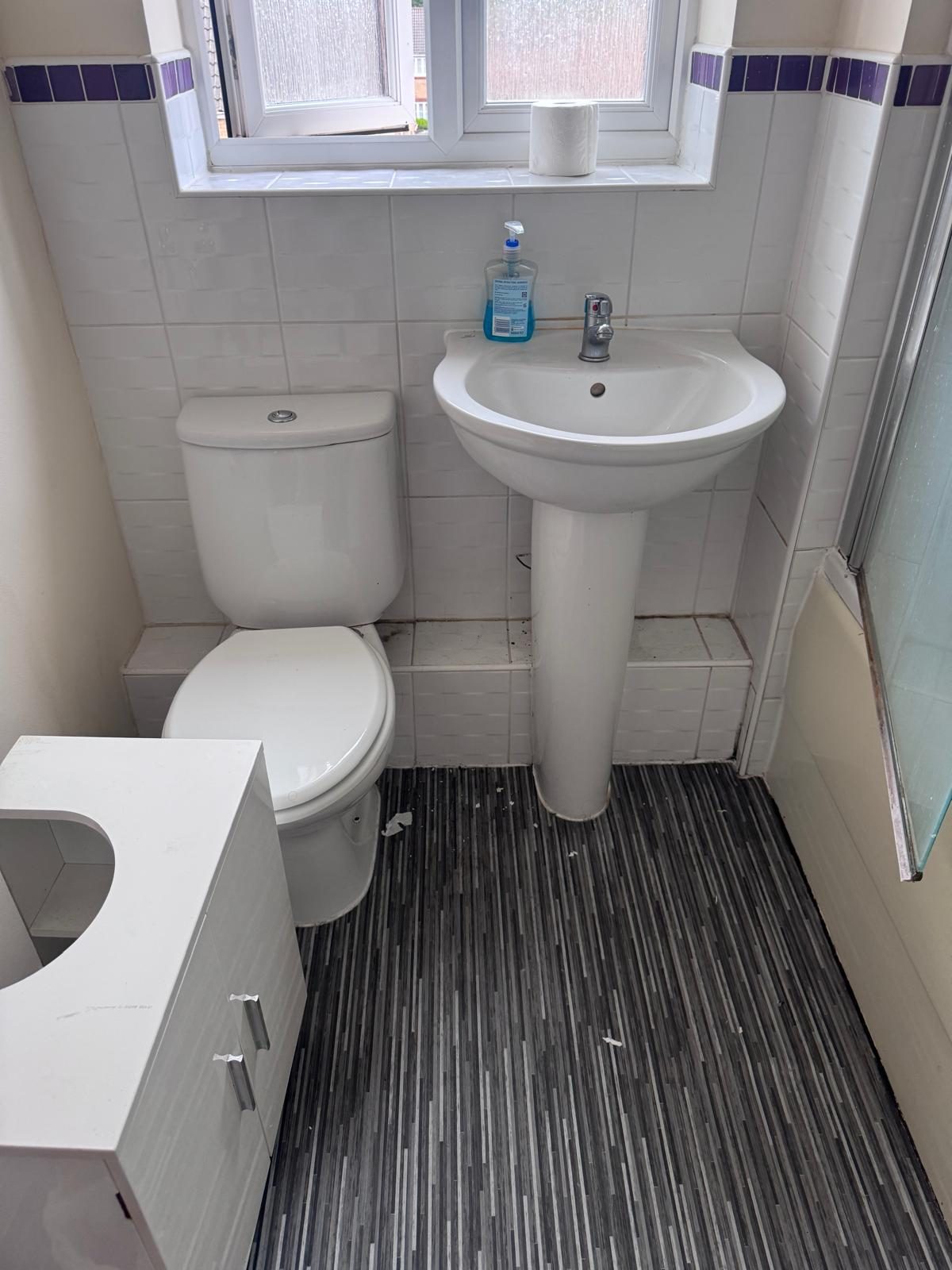 A sparkling clean bathroom with a fresh white pedestal basin in a Cwmbran home