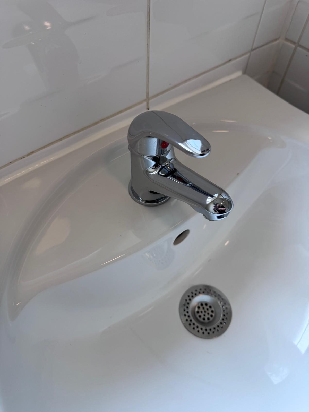 Close-up of a gleaming polished chrome basin tap — Pure Luxe's signature attention to detail