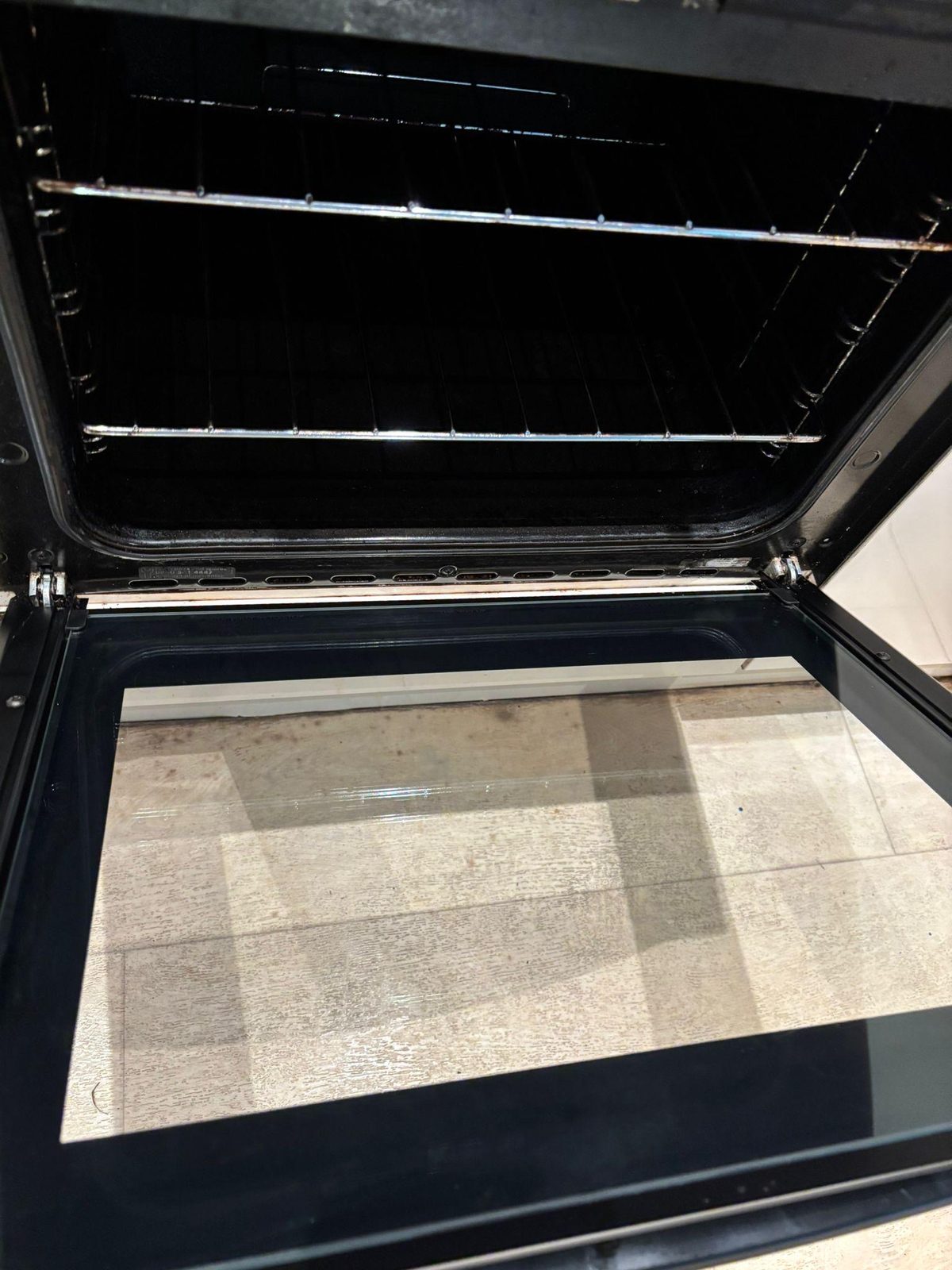 Oven interior after deep clean — spotless cavity and bright chrome racks